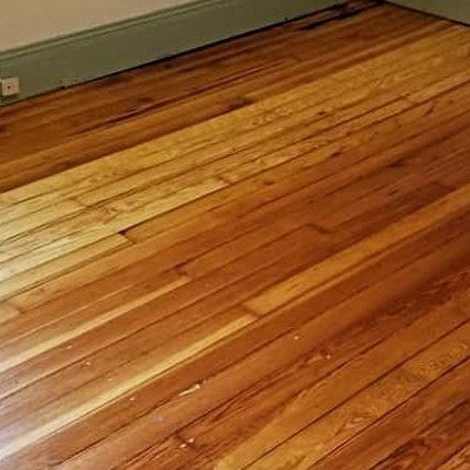 After: the same floor sanded and refinished to natural wood