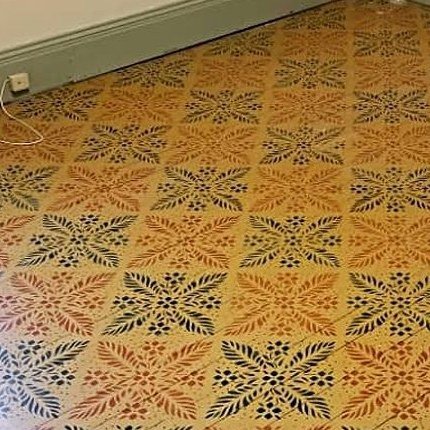 Before: floor with a decorative stenciled pattern