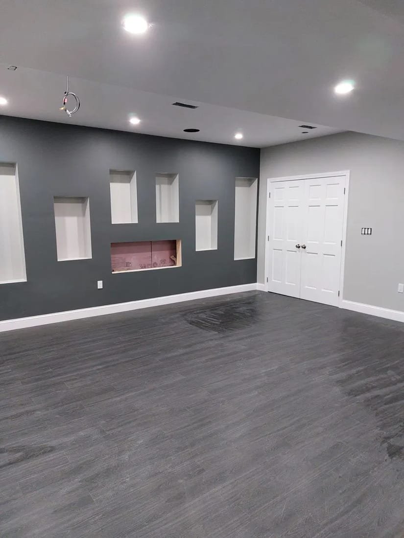 Refinished hardwood floor in a living space with accent wall