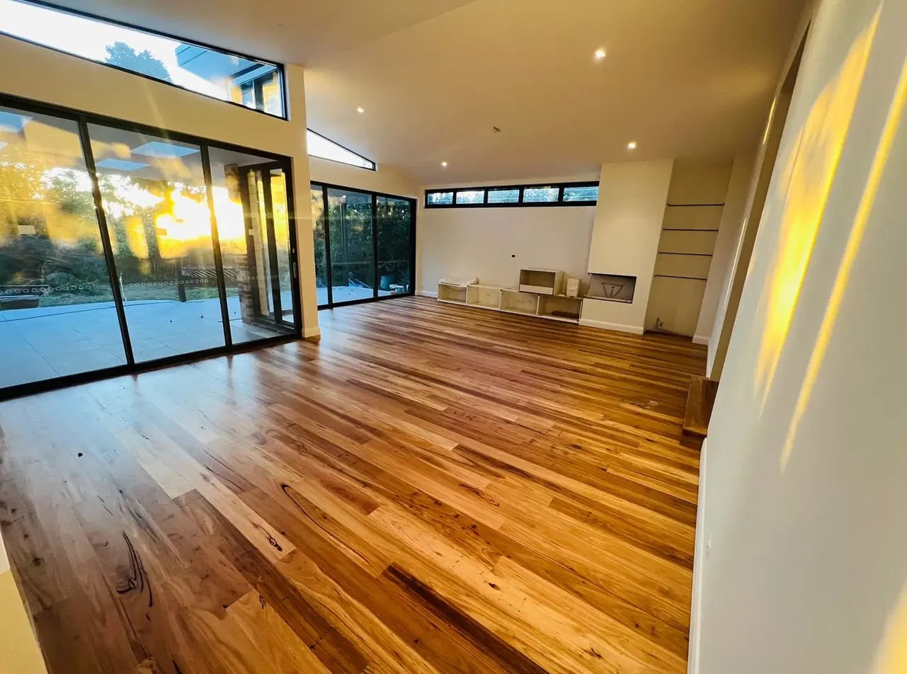 Refinished hardwood living room floor at sunset
